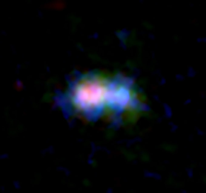 ALMA and Hubble Space Telescope (HST) image of the distant galaxy MACS0416_Y1. Distribution of dust and oxygen gas traced by ALMA are shown in red and green, respectively, while the distribution of stars captured by HST is shown in blue. Credit: ALMA (ESO/NAOJ/NRAO), NASA/ESA Hubble Space Telescope, Tamura, et al.