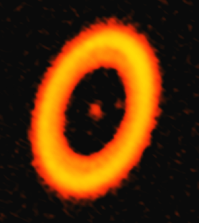 ALMA image of the dust in PDS 70, a star system located approximately 370 light-years from Earth. Two faint smudges in the gap region of this disk are associated with newly formed planets. One such concentration of dust is a circumplanetary disk, the first such feature ever detected around a distant star. Credit: ALMA (ESO/NAOJ/NRAO); A. Isella.