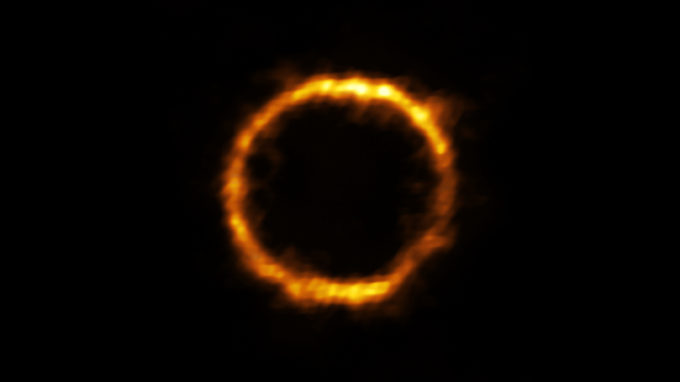 Astronomers using ALMA, in which the ESO is a partner, have revealed an extremely distant galaxy that looks surprisingly like our Milky Way. The galaxy, SPT0418-47, is gravitationally lensed by a nearby galaxy, appearing in the sky as a near-perfect ring of light. Credit: ALMA (ESO/NAOJ/NRAO), Rizzo et al.