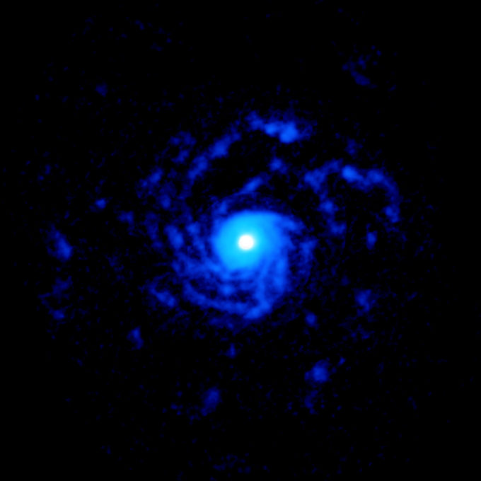 ALMA image of the planet-forming disk around the young star RU Lup, showing a giant set of spiral arms made out of gas. The structure extends to nearly 1000 astronomical units from the star. Credit: ALMA (ESO/NAOJ/NRAO), J. Huang; NRAO/AUI/NSF, S. Dagnello