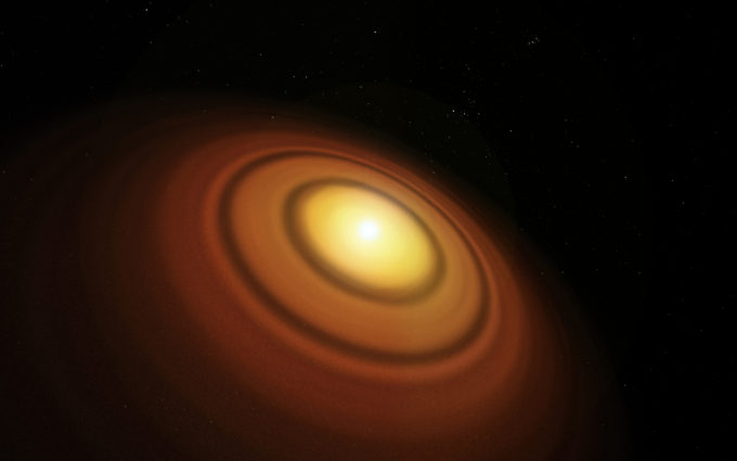 Esta ilustración muestra el disco protoplanetario conocido más cercano, que se encuentra alrededor de la estrella TW Hydrae, en la constelación meridional de Hydrus (la hidra macho). El Atacama Large Millimeter/submillimeter Array (ALMA) ha detectado en este disco la molécula orgánica del alcohol metílico (metanol). Se trata de la primera detección de este compuesto en un joven disco de formación planetaria. Crédito: ESO/M. Kornmesser