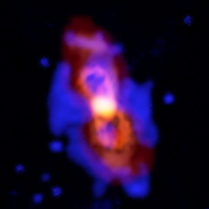 Composite image of CK Vul, the remains of a double-star collision. This impact launched radioactive molecules into space, as seen in the orange double-lobe structure at the center. This is an ALMA image of 27-aluminum monofluoride, but the rare isotopic version of AlF resides in the same region. The red, diffuse image is an ALMA image of the more extended dust in the region. The blue is optical hydrogen emission from the Gemini observatory. Credit: ALMA (ESO/NAOJ/NRAO), T. Kamiński & M. Hajduk; Gemini, NOAO/AURA/NSF; NRAO/AUI/NSF, B. Saxton