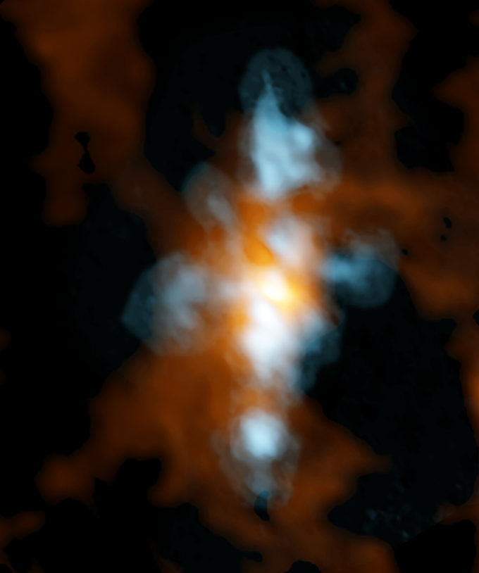 Imagen compuesta tomada en alta frecuencia por ALMA de NGC 6334I, una región de formación estelar en la Nebulosa de la Pata de Gato. En azul se muestra agua pesada (HDO) fluyendo hacia afuera desde ya sea una única protoestrella o desde un cúmulo de estas. En naranjo se muestra la emisión en continuo de la misma región, en que los científicos encontraron una gran variedad de moléculas, incluyendo glycoaldehido, la molécula más simple relacionada al azúcar. Crédito: ALMA (ESO/NAOJ/NRAO): NRAO/AUI/NSF, B. Saxton