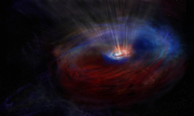 Artist impression of the heart of galaxy NGC 1068, which harbors an actively feeding supermassive black hole, hidden within a thick doughnut-shaped cloud of dust and gas. ALMA discovered two counter-rotating flows of gas around the black hole. The colors in this image represent the motion of the gas: blue is material moving toward us, red is moving away. Credit: NRAO/AUI/NSF, S. Dagnello.