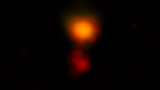 ALMA radio image of the dusty star-forming galaxy called MAMBO-9. The galaxy consists of two parts, and it is in the process of merging. Credit: ALMA (ESO/NAOJ/NRAO), C.M. Casey et al.; NRAO/AUI/NSF, B. Saxton