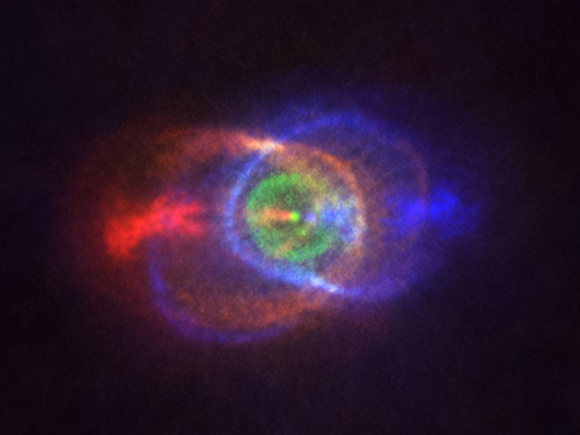 <p>This new ALMA image shows the outcome of a stellar fight: a complex and stunning gas environment surrounding the binary HD101584. The colours represent speed, going from blue — gas moving the fastest towards us — to red — gas moving the fastest away from us. Jets, almost along the line of sight, propel the material in blue and red. The stars in the binary are located at the single bright dot at the centre of the ring-like structure shown in green, which is moving with the same velocity as the system as a whole along the line of sight. Astronomers believe this ring has its origin in the material ejected as the lower mass star in the binary spiralled towards its red-giant partner.</p>
<p>Credit:<br />
ALMA (ESO/NAOJ/NRAO), Olofsson et al. Acknowledgement: Robert Cumming</p>
