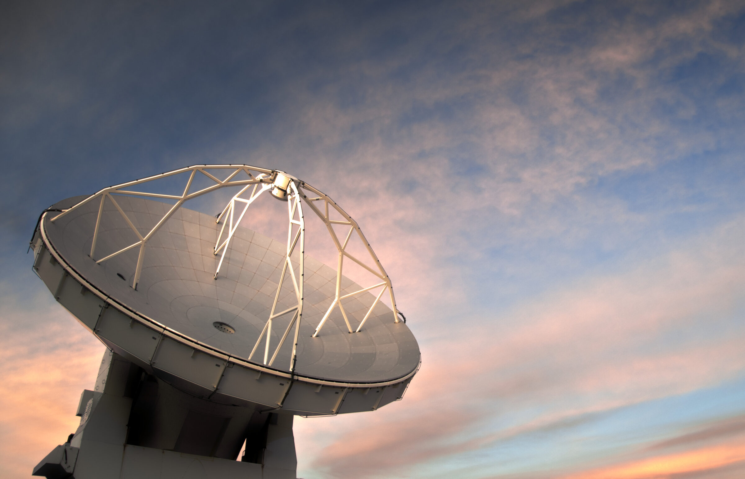 One of the 66 ALMA antennas against the backdrop of a rare cloudy sky