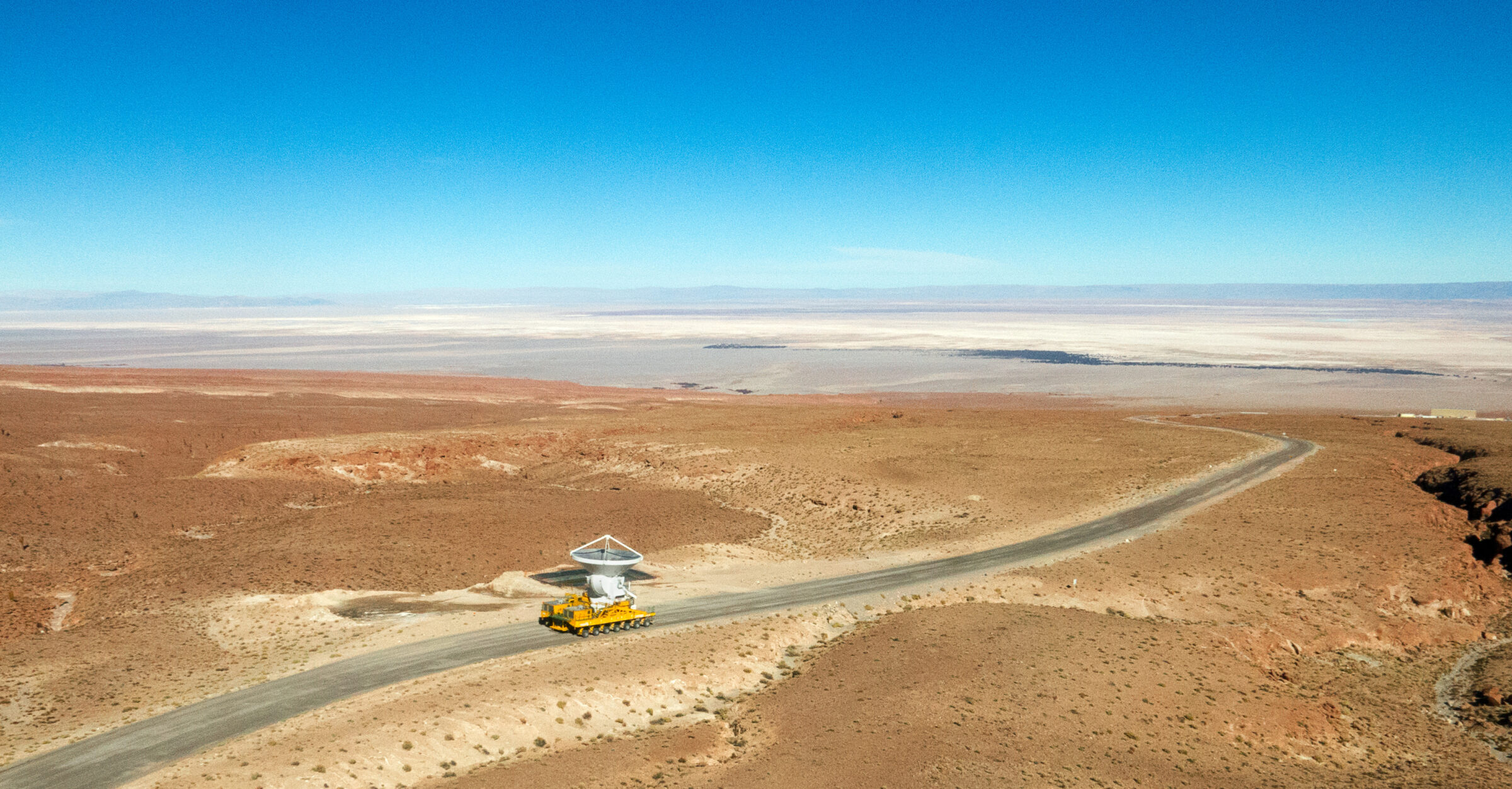 A transporter climbing the winding road to Chajnantor