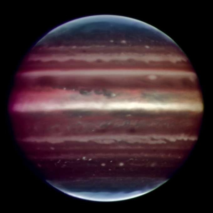 Amazing image of Jupiter taken in infrared light on the night of 17 August 2008 with the Multi-Conjugate Adaptive Optics Demonstrator (MAD) prototype instrument mounted on ESO's Very Large Telescope. This false colour photo is the combination of a series of images taken over a time span of about 20 minutes, through three different filters (2, 2.14, and 2.16 microns). The image sharpening obtained is about 90 milli-arcseconds across the whole planetary disc, a real record on similar images taken from the ground. This corresponds to seeing details about 300 km wide on the surface of the giant planet. The great red spot is not visible in this image as it was on the other side of the planet during the observations. The observations were done at infrared wavelengths where absorption due to hydrogen and methane is strong. This explains why the colours are different from how we usually see Jupiter in visible-light. This absorption means that light can be reflected back only from high-altitude hazes, and not from deeper clouds. These hazes lie in the very stable upper part of Jupiter's troposphere, where pressures are between 0.15 and 0.3 bar. Mixing is weak within this stable region, so tiny haze particles can survive for days to years, depending on their size and fall speed. Additionally, near the planet's poles, a higher stratospheric haze (light blue regions) is generated by interactions with particles trapped in Jupiter's intense magnetic field. Credit: ESO/F. Marchis, M. Wong, E. Marchetti, P. Amico, S. Tordo