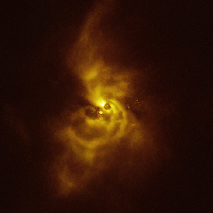 This image of the young star V960 Mon and its surrounding material was taken with the Spectro-Polarimetric High-contrast Exoplanet REsearch (SPHERE) instrument on ESO’s VLT. The material orbiting the young star is assembling together in a series of intricate spiral arms that extend to distances greater than the entire Solar System. Credit: ESO/Weber et al.
