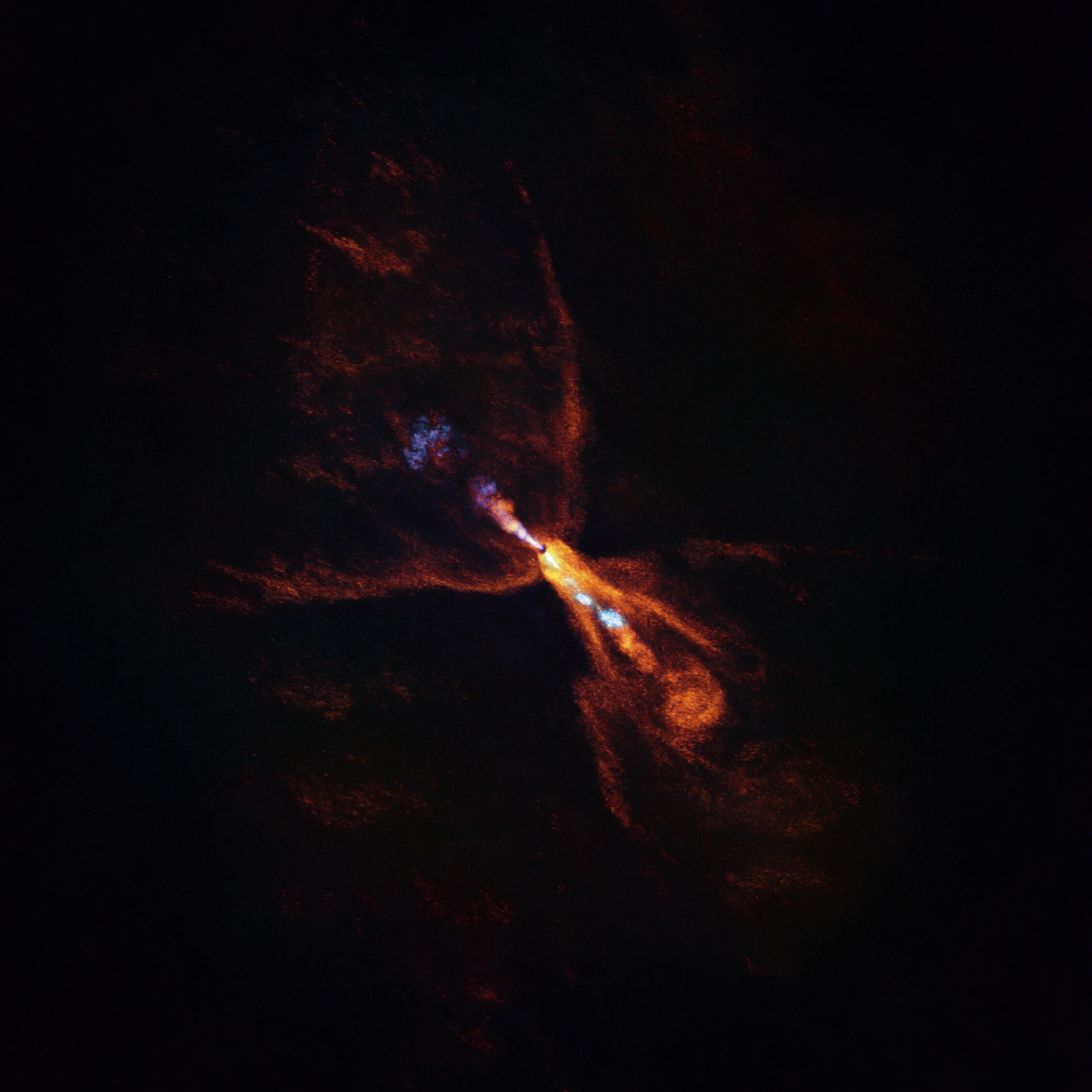 This is HOPS-315, a baby star where astronomers have observed evidence for the earliest stages of planet formation. The image was taken with the Atacama Large Millimeter/submillimeter Array (ALMA), in which ESO is a partner. Together with data from the James Webb Space Telescope (JWST), these observations show that hot minerals are beginning to solidify. In orange we see the distribution of carbon monoxide, blowing away from the star in a butterfly-shaped wind. In blue we see a narrow jet of silicon monoxide, also beaming away from the star. These gaseous winds and jets are common around baby stars like HOPS-315. Together the ALMA and JWST observations indicate that, in addition to these features, there is also a disc of gaseous silicon monoxide around the star that is condensing into solid silicates –– the first stages of planetary formation. Credit: ALMA(ESO/NAOJ/NRAO)/M. McClure et al.